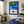 Children's room with racing car-themed decor, including a framed picture of a racing car on a checkered track.