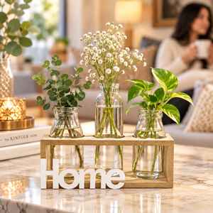 Three glass bottle vases in a natural-tone Home holder with flowers and greenery